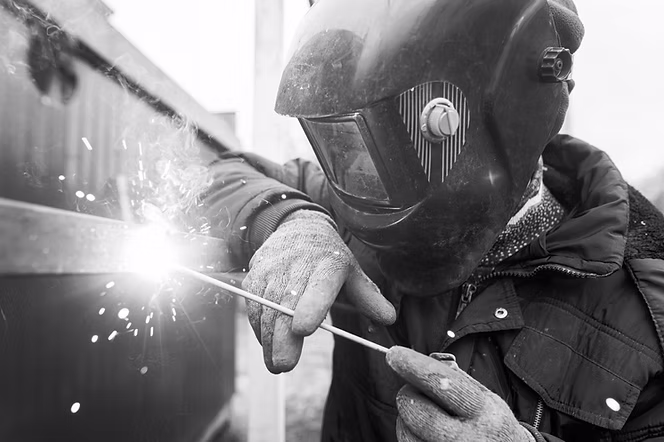 Arc welder welding a steel part